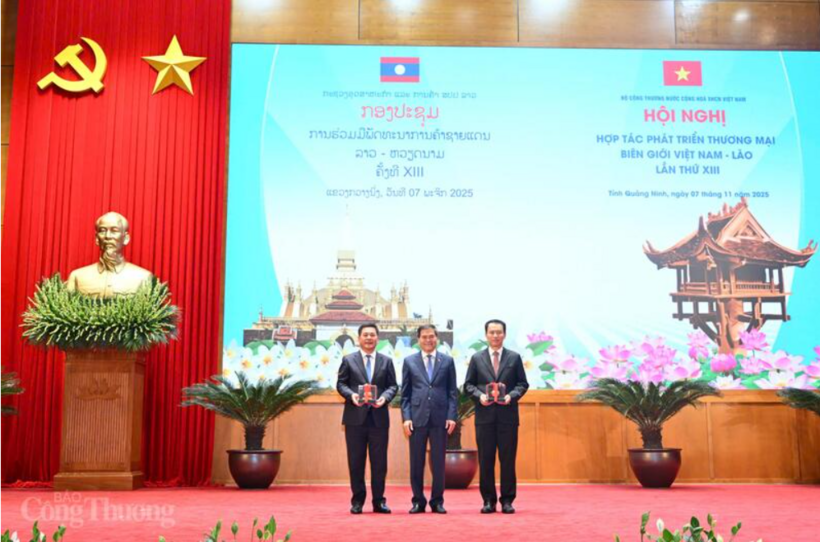 The Chairman of the Quang Ninh provincial People’s Committee presents souvenirs to the Vietnamese and Lao Ministers of Industry and Trade. Photo: Can Dung