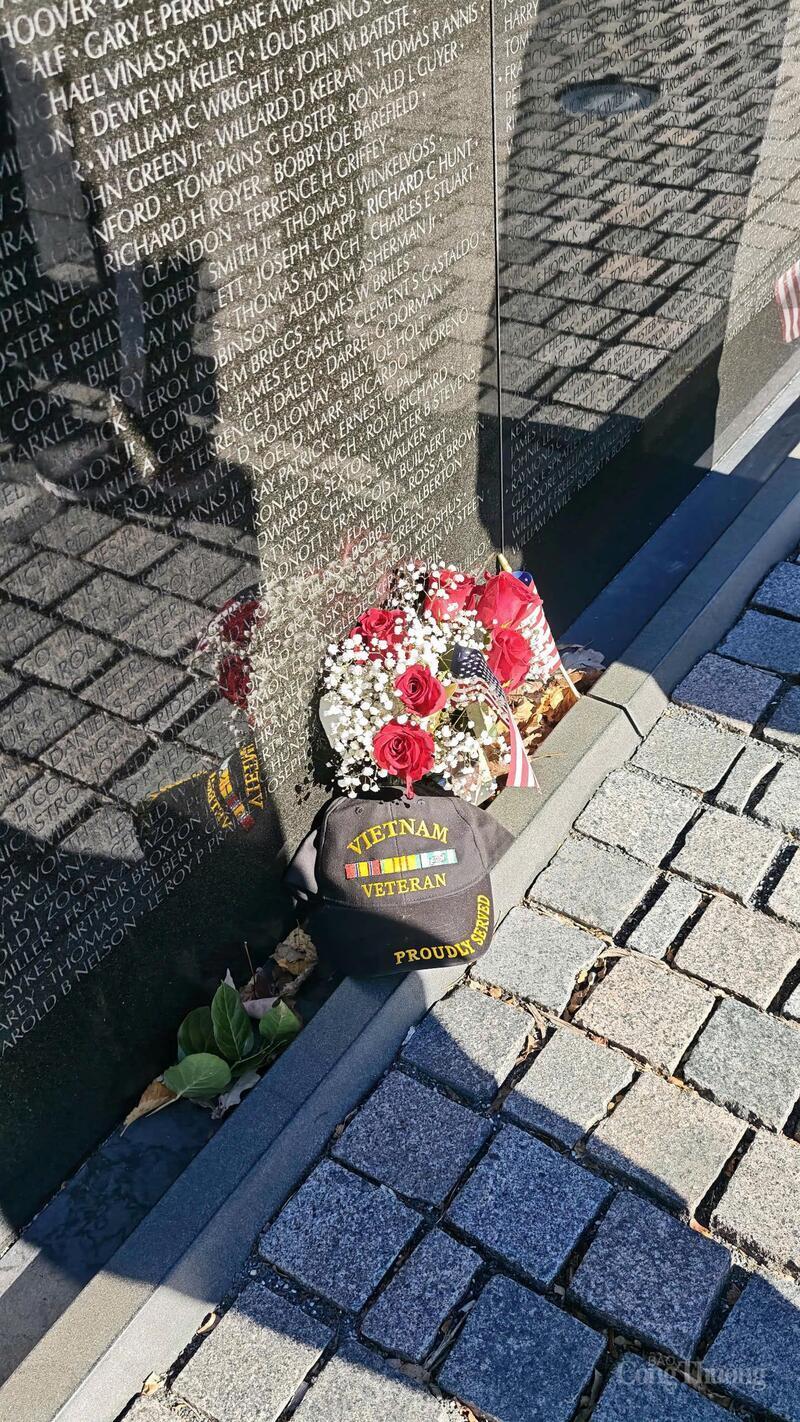 The word “Vietnam” appears on the clothing of numerous participants and on various commemorative items.