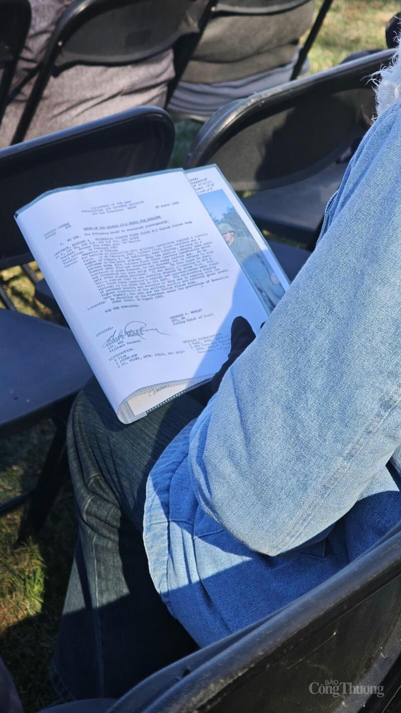 An elderly woman with a keepsake of a loved one.