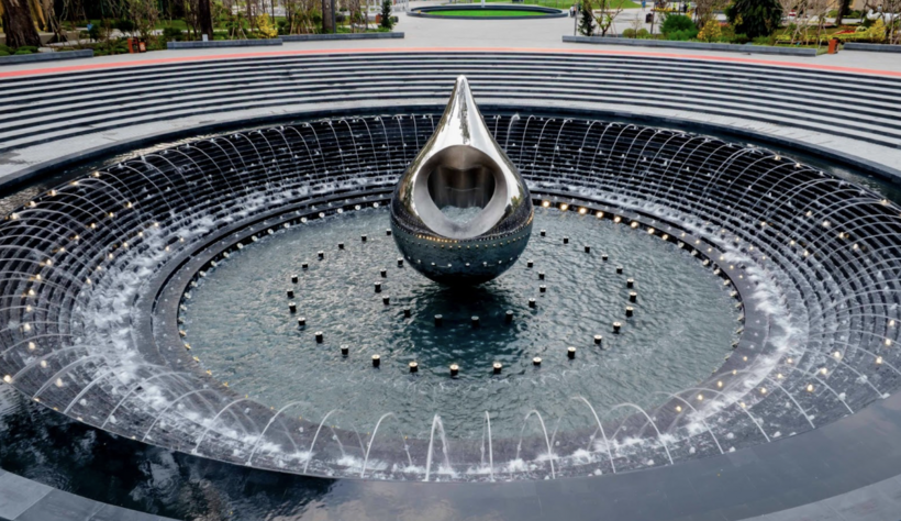 The Water Drop Monument in mirror polished stainless steel, set within a central plaza.