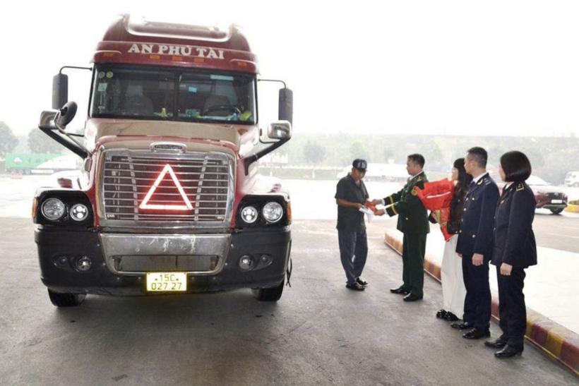 Border gate officials present lucky money to the driver transporting the first export shipment of the Lunar New Year