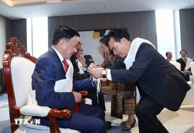 Standing Member of the CPV Secretariat Tran Cam Tu attends Laos’ traditional Baci (wrist-tying) ceremony. Photo: VNA