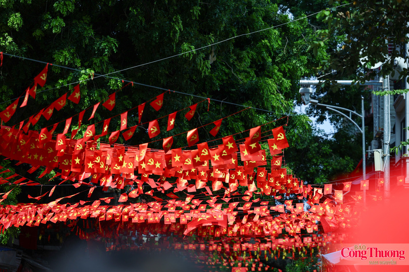 Red flags bearing yellow stars line Hanoi's streets as autumn arrives in the capital.