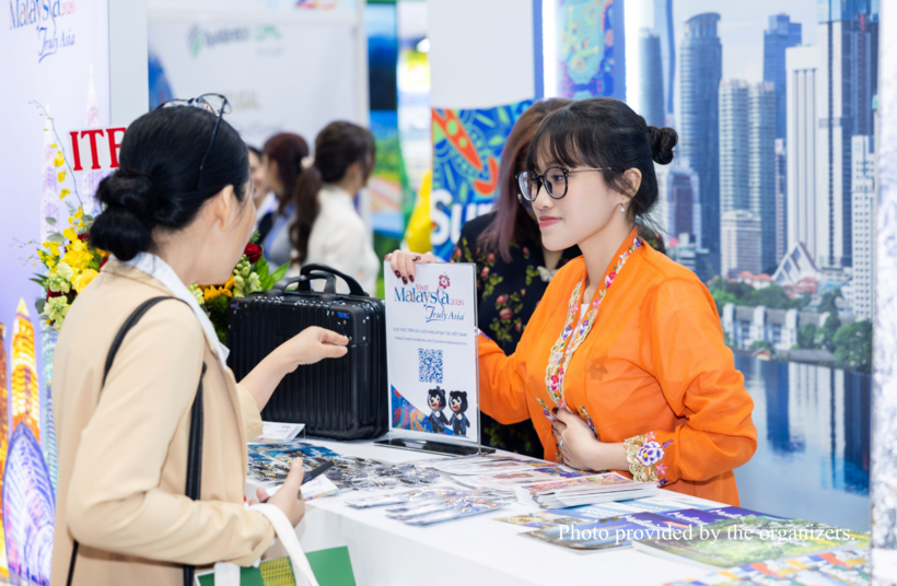 Visitors explore tourism information at the Tourism Malaysia booth during ITE HCMC 2026.
