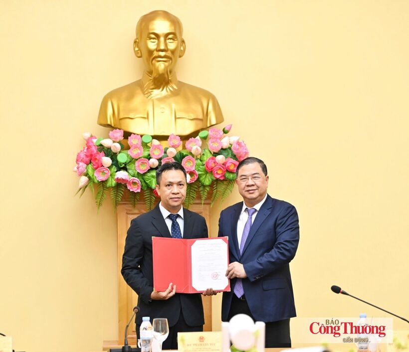 Politburo member and Standing Deputy Prime Minister Pham Gia Tuc hands over the appointment decision to Deputy Minister of Industry and Trade Nguyen Viet Son.