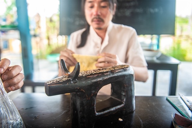 An artist creates a lacquer from driftwood. It is a 'green' and sustainable tourism destination in the town. — Photo courtesy of Lê Ngọc Thuận An artist creates a lacquer from driftwood. It is a 'green' and sustainable tourism destination in the town. — Photo courtesy of Lê Ngọc Thuận