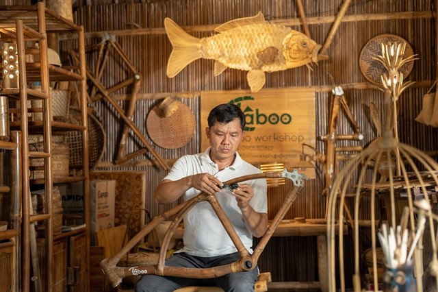 Võ Tấn Tân, a craftsman, is adorning a bicycle frame with bamboo in his personal workshop located in the Cẩm Thanh Commune, Hội An. The historic town is now a proud member of the UNESCO Creative Cities Network (UCCN), specifically in the Crafts and Folk Art category. — Photo courtesy of Sơn Ca Võ Tấn Tân, a craftsman, is adorning a bicycle frame with bamboo in his personal workshop located in the Cẩm Thanh Commune, Hội An. The historic town is now a proud member of the UNESCO Creative Cities Network (UCCN), specifically in the Crafts and Folk Art category. — Photo courtesy of Sơn Ca