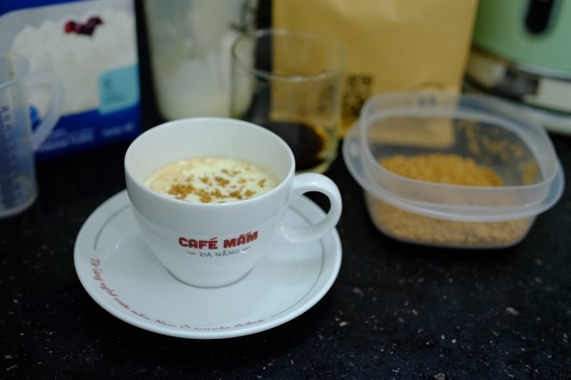 A cup of coffee topped with concentrated dried fish sauce powder is introduced in Nam Ô fish sauce village in Đà Nẵng. Visitors here can explore fish sauce production and taste the sauce with a few sips of coffee. Photo courtesy of Nhật Huy A cup of coffee topped with concentrated dried fish sauce powder is introduced in Nam Ô fish sauce village in Đà Nẵng. Visitors here can explore fish sauce production and taste the sauce with a few sips of coffee. Photo courtesy of Nhật Huy