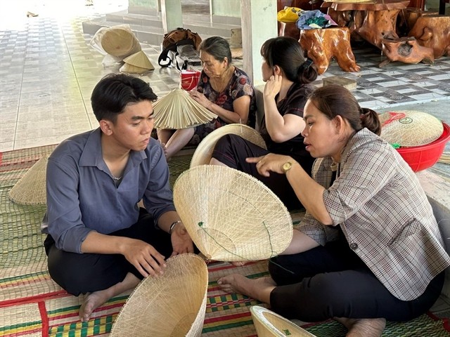 ARTS AND CRAFTS: A visitor learns how to make a conical hat in Phú Gia Conical Hat Making Village. VNS Photo Thiên Kim ARTS AND CRAFTS: A visitor learns how to make a conical hat in Phú Gia Conical Hat Making Village. VNS Photo Thiên Kim