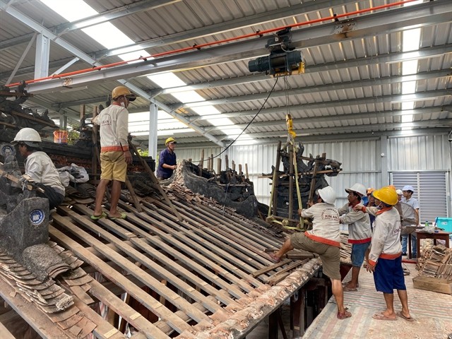 Workers repair and relocate on roof tile items of the Japanese Bridge restoration project. The repair works started in late 2022. Photo courtesy of Hội An's Centre for Cultural Heritage Management