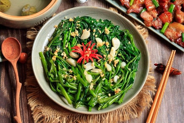 Rau muống xào tỏi (morning glory stir-fry) is included in top 100 Asian stir-fry dishes of TasteAtlas. — Photo Cơm Nhà Facebook