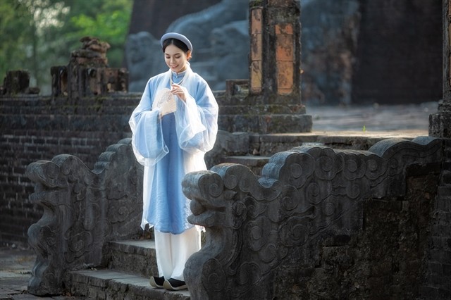 A model in traditional Áo Dài or long dress of Huế style. The wearing of áo dài (traditional long dress) costume and tailoring craft of áo dài has been recognised as the National Intangible Heritage by the Ministry of Culture, Sports and Tourism. — Photo courtesy of Thừa Thiên-Huế Province's Department of Culture and Sports A model in traditional Áo Dài or long dress of Huế style. The wearing of áo dài (traditional long dress) costume and tailoring craft of áo dài has been recognised as the National Intangible Heritage by the Ministry of Culture, Sports and Tourism. — Photo courtesy of Thừa Thiên-Huế Province's Department of Culture and Sports
