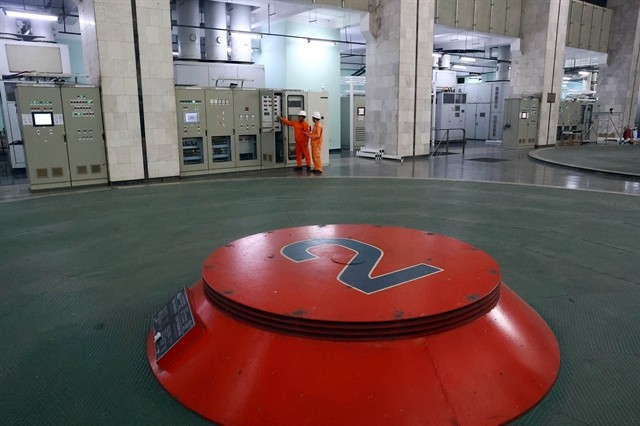 Engineers check the relay protection cabinet of machine unit No 3.