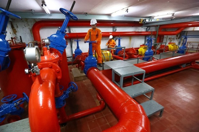 Workers check the fire protection system.