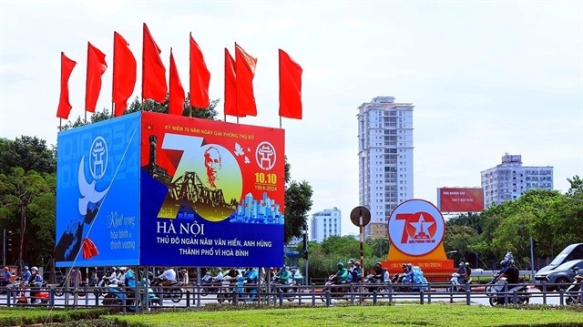 A large poster at Giải Phóng-Đại Cồ Việt Intersection which reads 'Hà Nội the thousand-year-old heroic city and a city for peace'. A large poster at Giải Phóng-Đại Cồ Việt Intersection which reads 'Hà Nội the thousand-year-old heroic city and a city for peace'.