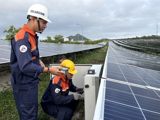 Engineers from Phong Phú Solar Farm in Tuy Phong District, Bình Thuận Province check the solar power system. — VNS Photo Khánh Dương