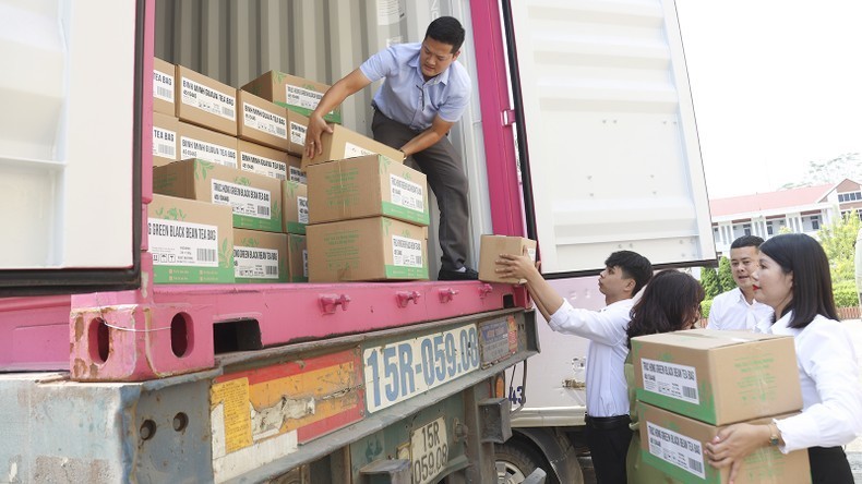 Goods are loaded onto a container for export