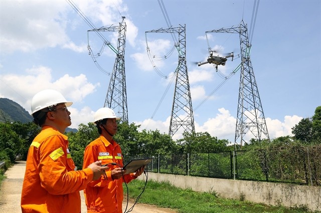 Workers of EVN use drones to check the transmission system in Lâm Đồng Province. — VNA/VNS Photo Huy Hùng