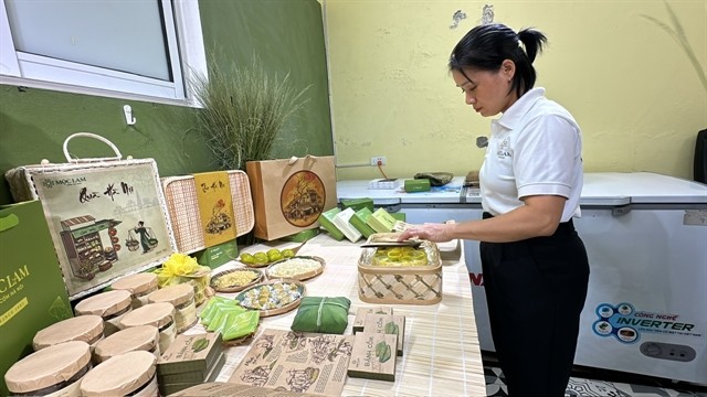 Vũ Thị Phúc prepares cốm products for her customers. VNS Photo Lê Hương Vũ Thị Phúc prepares cốm products for her customers. VNS Photo Lê Hương