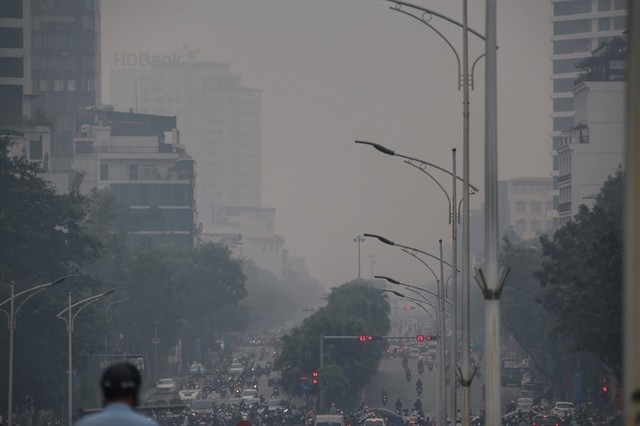 High-rise buildings on Văn Cao Street are hidden behind a thick layer of pollution.