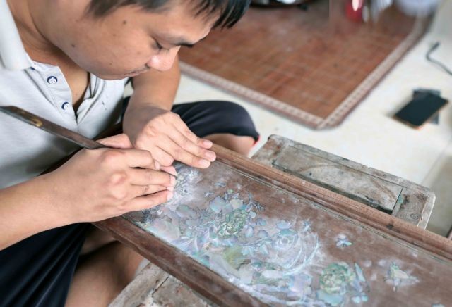 An artisan refining and finishing the artwork.