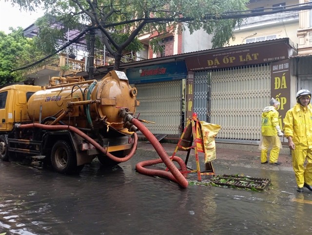Workers of Hà Nội Sewerage and Drainage Company drain the water after the flooding caused by Typhoon Yagi in September. VNA/VNS Photo