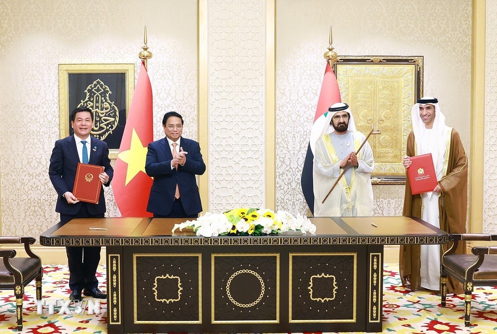 Vietnamese Prime Minister Pham Minh Chinh (second left) and UAE Vice President and Prime Minister Sheikh Mohammed bin Rashid Al Maktoum (second right) witness the signing ceremony of the CEPA agreement - photo: VGP