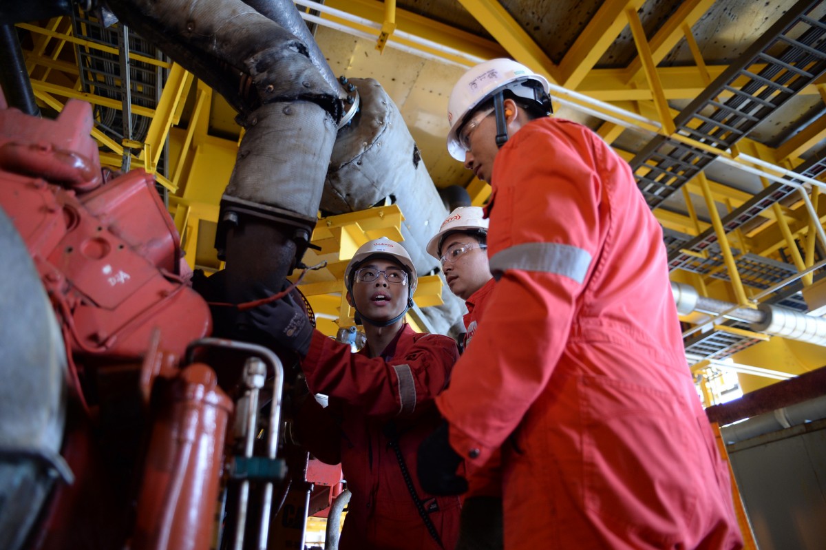 Workers on the White Lion oil field production platform